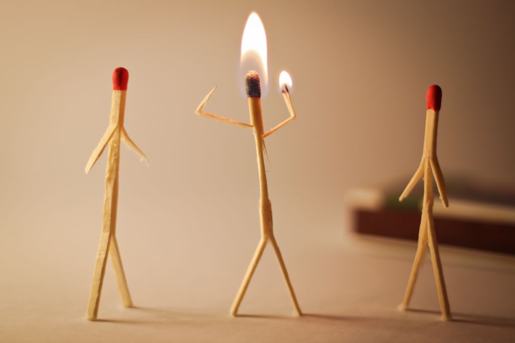 Artistic matchstick figures arranged with flames showcasing creativity and craftsmanship.